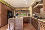 Kitchen is Well Equipped and Features Center Island & Breakfast Table